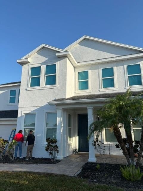 Crew applying exterior paint on-site