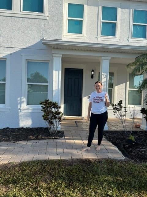 Freshly painted entry with navy door and white stucco